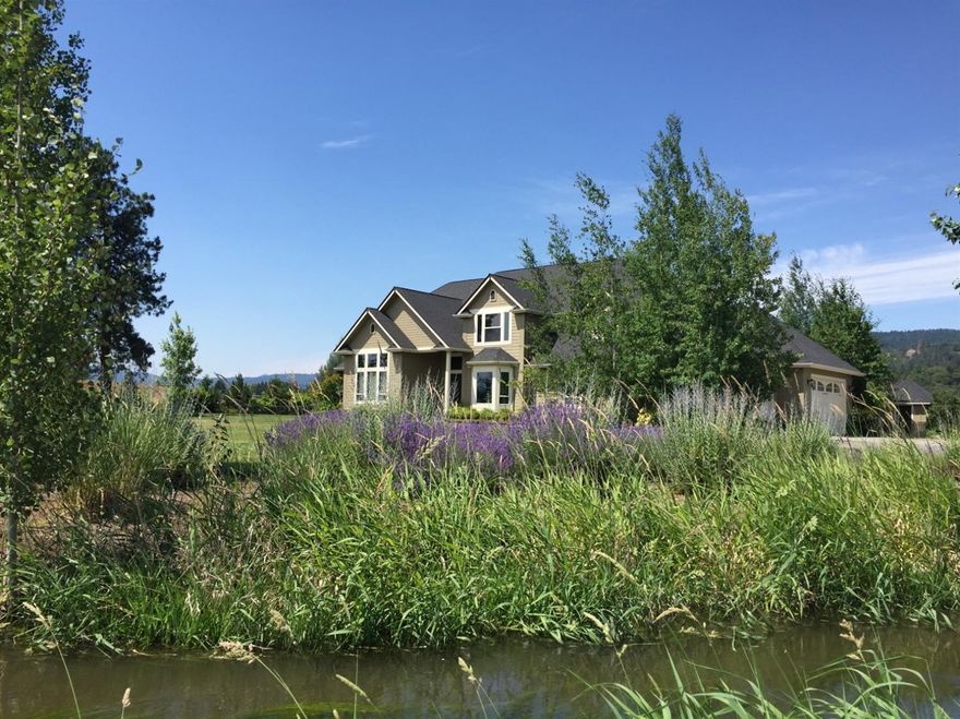 This STUNNING estate situated on 21.5 irrigated acres would make an exceptional vineyard with its close proximity to town and the Applegate Valley. The residence features a grandiose entry opening to 25' ceilings in the great room, floor to ceiling windows capture amazing views of all surrounding mountains & the snow-capped McLaughlin. A true chef's kitchen features slab granite counters, upgraded appliances, 3 sinks, coffee bar, pantry, & butler's pantry with ample storage. The master en-suite features dual vanities, and walk-in shower, jetted tub, travertine marble floors, walk-in closet and 2 custom armoires. Custom Venetian plaster walls, surround sound system, central vac & new geo-thermal system are just a few of the incredible amenities this home features. The barn features a tack room, 3 stalls w/ covered & matted runs, & hay storage. 2 outdoor arenas, pivot irrigation system, guest house, too much to list! There is nothing not to like about this estate!