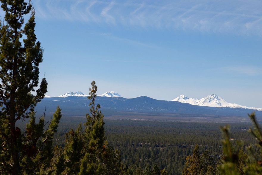 Perched atop the scenic hills of Awbrey Butte in Bend, this stunning 2,600 sq. ft., 3-bedroom, 3-bath home offers an unparalleled vantage point with breathtaking views of eight Cascade peaks—a rare and coveted sight. Recently remodeled to blend modern luxury with classic Northwest charm, this home is designed to embrace its extraordinary surroundings. Expansive windows  frame awe-inspiring mountain vistas, filling the space with natural light. The gourmet kitchen, features stainless steel appliances, quartz countertops, and custom cabinetry,  perfect for both casual mornings and elegant entertaining. The spacious primary suite boasts a cozy sitting area and bay windows, offering a front-row seat to the beauty of the Cascades. Step onto the expansive back deck to savor morning coffee at sunrise or unwind with a glass of wine at sunset. The driveway is heated with a sensor for those snowy days!  This is a rare opportunity to own a piece of Central Oregon paradise