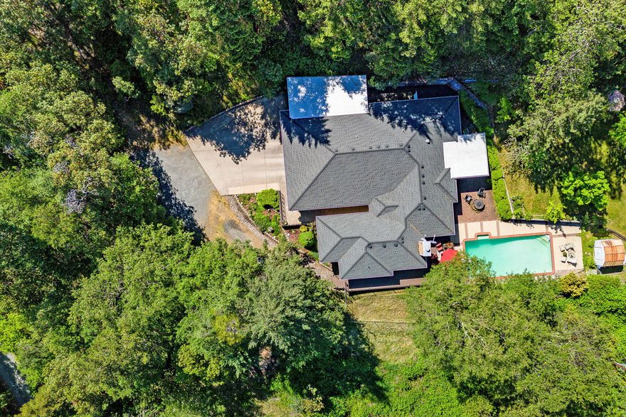 Price Improvement!  20 acres located in SW Medford just outside of Jacksonville. Tranquil setting offers the perfect balance between seclusion and convenience. Split floor plan with 4 bedrooms, 2 bathrooms, beautiful wood floors, kitchen has granite countertops, large island, cook top, double wall oven and ample storage. Living room with wood burning fireplace, cozy family room, formal dining area plus separate eating area. Enjoy the private deck looking over the pool and beautiful forest or relax in the enclosed sun room. In-ground pool, 3 sheds, 3-car garage and a carport...Room for all your toys!  New Roof in 2011, Heat Pump in 2014, Composite deck in 2018 and pool pump motor in 2022. Whether you're seeking a peaceful sanctuary or a place to entertain family and friends, this exceptional property offers it all.
