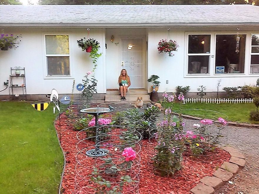 Peaceful country living comes to you in this 1,807 s.f. 3-bed/2-bath home built in 2004 with attached 2-car garage on two fully fenced acres with strong well (11.6/gpm-2015 test). Well insulated with 2x6 construction, double-pane windows and a whole house fan to remove hot air in summer. A certified Lopi woodstove, Monitor oil heater and electric wall heaters in each bedroom will keep you warm in the winter months. Lifetime guaranteed composite flooring, new carpeting in all bedrooms, remodeled guest bath, open floor plan, pantry and breakfast bar in kitchen, sliders from DR to back yard. Master bedroom is large with walk-in closet and bathroom with two other nice-sized bedrooms. Outdoors there is an 18x8x4 above-ground pool with nearby deck to entertain. Mature fruit trees, lots of flowers (see pics from last Spring!), garden area and a chicken coop complete country living at its best. There is also a detached 16x8 outbuilding with storage AND a lifetime pest control program!