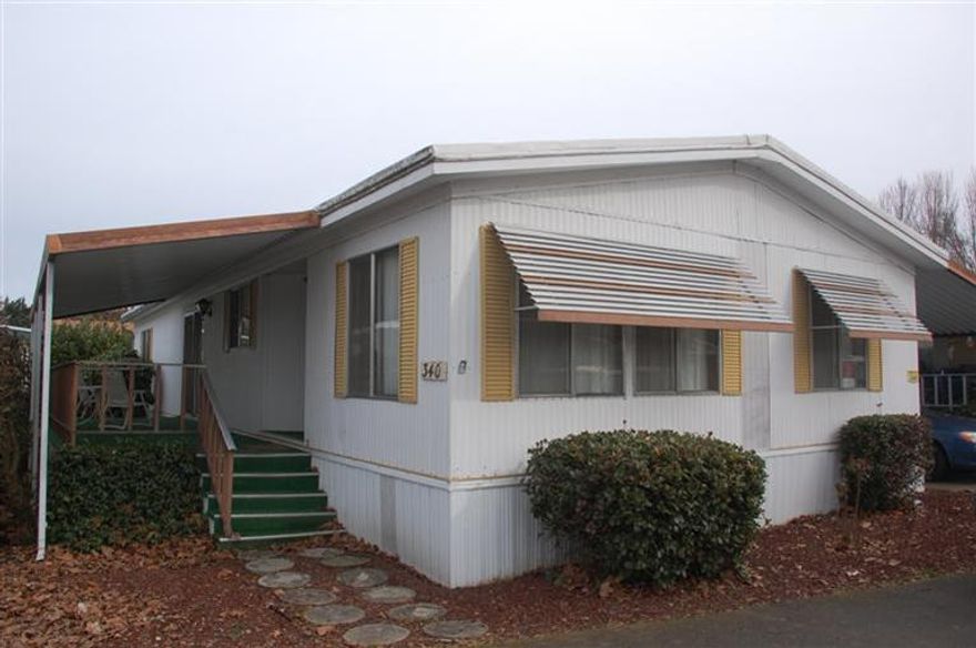 Spacious double-wide in desirable Country Estates Mobile Park along the Rogue River. 55+ Park, buyer to qualify w/ park. 2 bedroom, 2 full bath, large living room, built-in hutch in dining area, separate den or family room, large retro-cool kitchen with rounded peninsula island. Lots of built-ins, walk in closets in both bedrooms. Soaker tub in master suite. All appliances and even potential to purchase personal property & furniture. Needs TLC but priced accordingly.