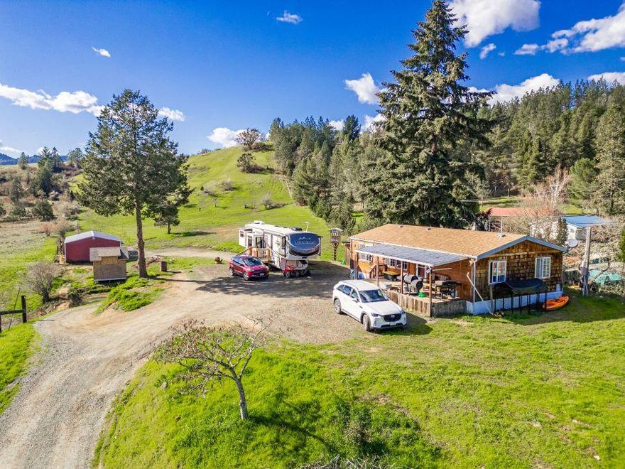 MUST sell! -make offer. Hobby Farm w/Seller concessions possible w/ acceptable offer! Here is the opportunity you have been seeking! Live in the existing 3 bd/2 ba mfg home & enjoy your 7+ acres, or consider building your new home either up on the knoll overlooking the valley and nature, or on existing homesite. Home has appx 5 yr old roof, laminate flooring, kitchen range is 5 burner and two ovens (can be used as convection) 3 bdrms, 2 baths. Back outside you also get an approved new pond, a large 4 stall barn with room for equipment, and a new gnl purpose building also approved and ready for your personalization. Seller is continuing to improve the property- Fenced perimeter areas. The choices for you abound and now at a lower price! Located within minutes of city amenities such as shopping, medical, dining and recreation. Easy access to recreation of all types. Let's make a deal!!!