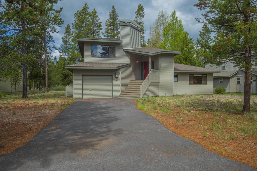 Ideally located near the Sunriver Marketplace and Woodlands Golf Course, this 3 bedroom Sunriver home offers a flexible split-level layout, comfortable living spaces, and an excellent opportunity to personalize in a well-established neighborhood. Vaulted wood ceilings and large windows bring in abundant natural light across the main living area, while the open kitchen and dining space connect easily to the living room with access to the upper deck for indoor-outdoor living. All bedrooms are located on the lower level, along with a bonus nook tucked beneath the stairs that works well for kids, play, or storage. Outdoor features include an elevated deck, a lower deck with a private hot tub, a lightly treed yard with space to relax or garden, and a single-car garage for bikes and gear.