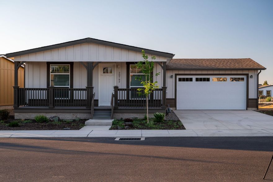 Welcome to Cascade Village, Bend's premier 55+ manufactured home community. Step inside your dream home, the Silver Crest model, where modern elegance meets functional design. This plan boasts a spacious 9-foot ceiling that enhances its contemporary appeal. The heart of the home features a sleek stainless steel appliance package and a stylish farmhouse sink, perfect for culinary enthusiasts. Columbian Walnut hardwood cabinets provide both beauty and practicality, while the Oak vinyl flooring adds a touch of charm. Central A/C offers year-round comfort as part of the Energy Star rated equipment in this efficient new home. The kitchen and bathrooms showcase a sophisticated aesthetic, and the primary bath features a luxurious granite shower, creating a spa-like retreat. Enjoy the ambiance created by the open floor plan, making this home perfect for entertaining and everyday living. This residence is not just a house; it's a lifestyle that combines comfort, style, and sustainability.