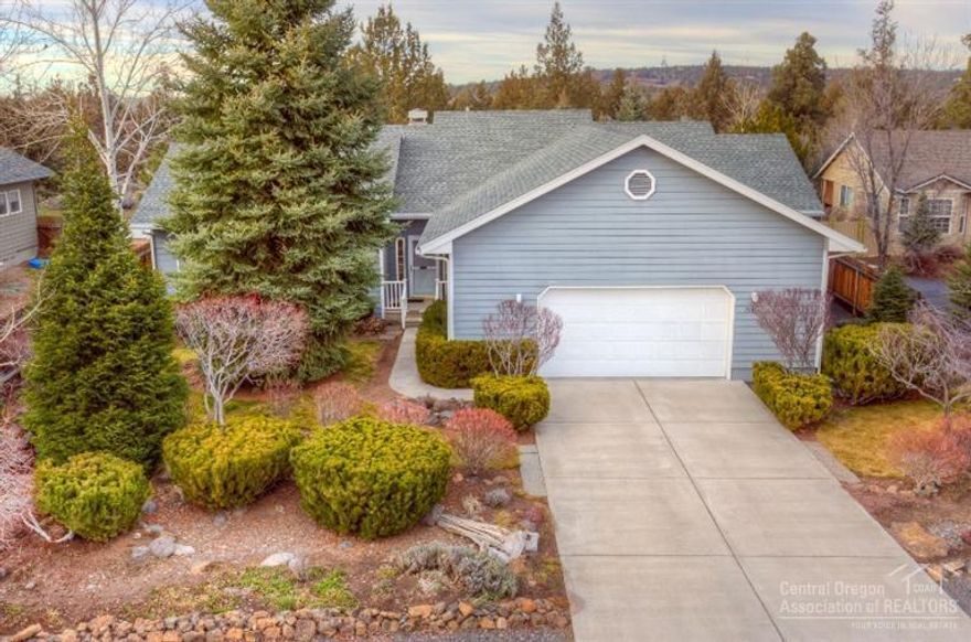 Wall of windows brings outdoor beauty and freshness into the light and bright great room. Meticulously maintained over 2000sqft with 3 bedrooms, 2 baths, fireplace, pantry, 669sqft oversized double car garage. Large mature Landscaped homesite adjoins natural common area. Low fees and great benefits of HOA include 170 acres of common area, playground, fenced dog park, walkingtrails, and starry nights. Free green disposal site. Easy access to Bend and Redmond. Low cost secure RV storage available.