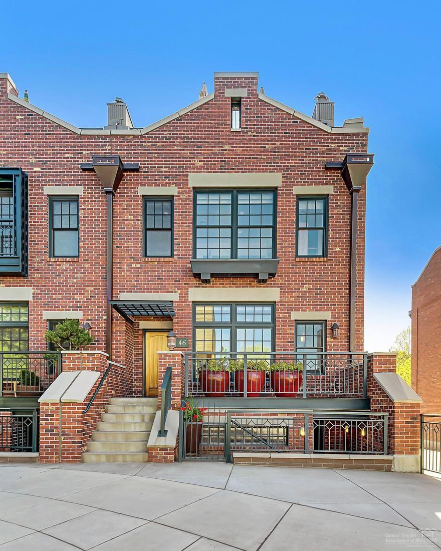 This Brownstone-style townhome is ideally located in the Mill Quarter between Downtown Bend and the Old Mill district. Modern finishes throughout include ceramic tile, slab surfaces and custom cabinetry. Great room main level includes chef's kitchen with Viking appliances and multiple decks. Well-appointed beds & baths with Live/Work option. Incredible Cascade views from the roof top terrace. Elevator services all floors. Two-car garage, excellent storage & no HOA! Sophisticated urban living built to last!