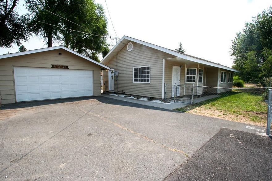 Newer home with fresh paint inside and out. Large 2 car detached garage with room for a shop. 3 bedrooms and 2 baths, patio and fully fenced yard. Separate laundry room off of the kitchen. This a super cute, clean home.