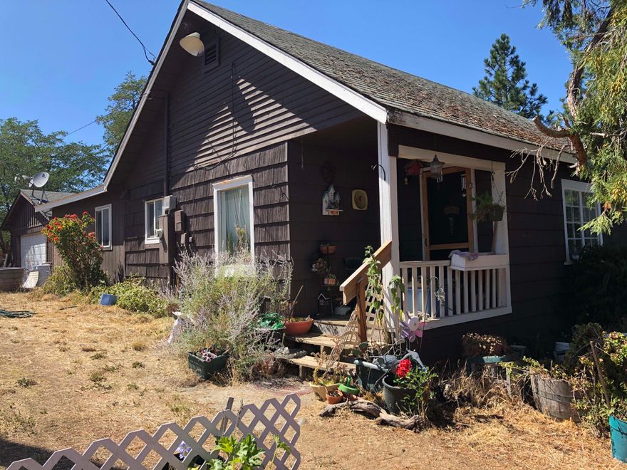 Two homes on 1 lot!  The main home features 2 bedrooms and 1 bath in 973 sq ft (per assessor.  There's an additional 440 sq ft (per assessor) studio apartment currently rented for $700/month, attached to the detached 2-car garage.  Both homes were built in 1945, and will require a lot of elbow grease to shine again. Rebuild, keep as is and rent both units, or live in one and rent the other.  The lot is almost 1/2 acre in size with a great eastern view of Medford, close to schools, shopping, and I-5 access.