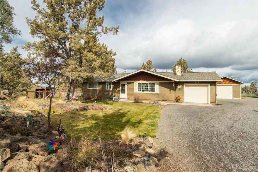 Enjoy the wide open spaces with this perfect home and 2.27-ac horse property close to NE Bend. Extensively updated single-level home in immaculate condition has loads of appeal. Improvements include paint, flooring, kitchen cabinets w/ granite countertops, ductless heat pump/AC, pellet fireplace insert and pasture fencing. Landscaped front and rear w/ large deck, yard area and fire pit. Detached 1428-sf RV/shop/storage building w/ roll-up door. Horse shelter, dry and grass paddocks. BLM is two blocks away.