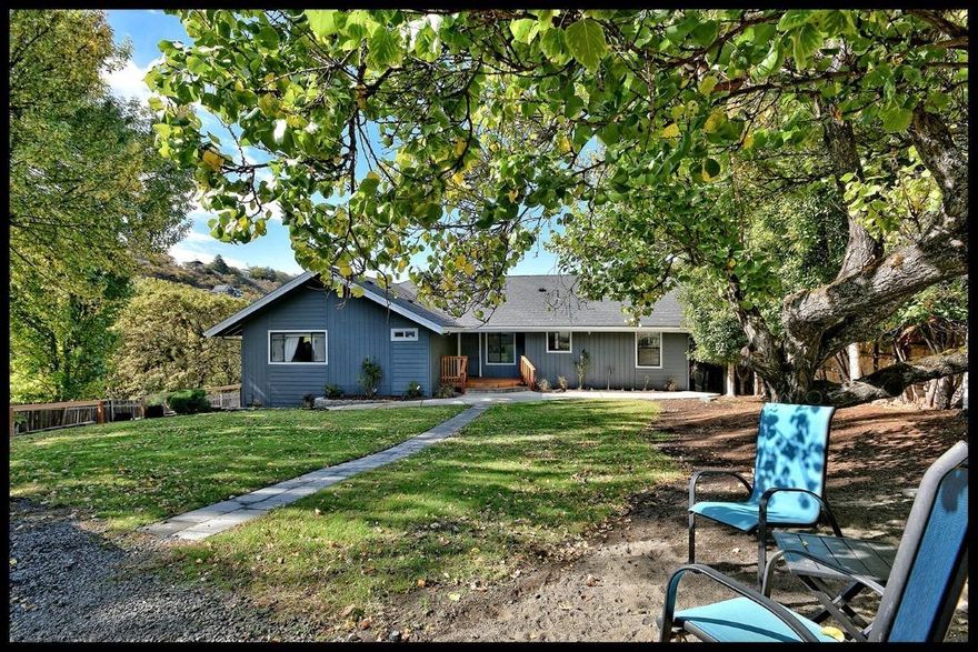 Ideal setting with a long private driveway to this completely updated home with views on park-like .69 acre lot. Beautiful city, valley & mountain views! Main level living. Floor plan offers high, vaulted ceilings, spacious rooms & natural lighting throughout. Extra-large master bedroom suite w/updated bath. Remodeled kitchen features full high-end stainless- steel appliance suite & custom cabinetry. 3 bedrooms & 2 full bathrooms on main level. 4th Bedroom/ bonus room in daylight basement plus full bathroom. Recent updates include all new upgraded flooring, brand new custom decking front & back, new interior and exterior paint. Large 2 car garage & RV parking. Apple trees, walnut trees, grape arbor & apricots too. Detached exterior custom shed. This is not a drive-by! Private setting makes viewing from road difficult.