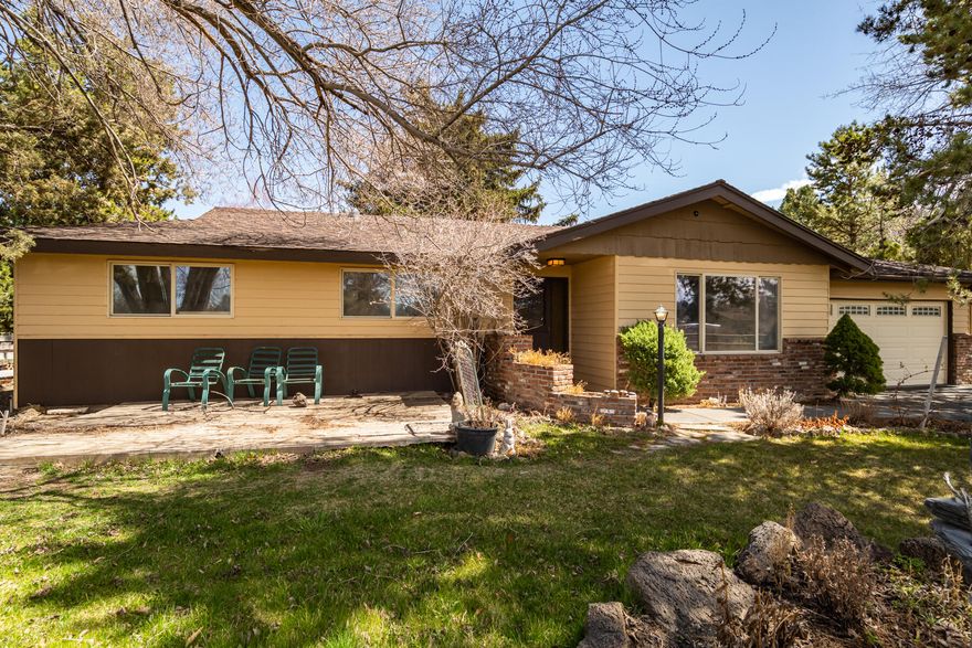 Spectacular setting and close to everything Bend has to offer. This is the one you've been waiting for. Open great room floor plan in this cute 3 bedroom, 2 bath, 1370 sqft single level ranch home situated on a 1 acre parcel with .66 acres of COI irrigation. This amazing home features a spacious great room complete with wood beam accents, wood burning fireplace insert with stone hearth and plenty of natural light. Upgraded kitchen complete with tile floors and cozy dining area. Private master suite with master bathroom and sliding glass door to the back deck. Parklike setting with mature trees, amazing greenhouse with vegetable garden, chicken coop, 1152 sqft barn, plus much more. Perfect for entertaining. Conveniently located in SE Bend and just a few minutes from town.  Call your broker for a private tour today.