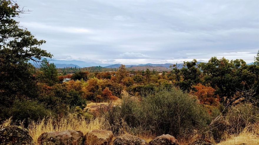 Multi-family setup in So Oregon! Situated on over 5 acres sits a very well cared for manufactured home with 2 car garage and ample living space above the garage. Overnight guests can stay in the rustic and fully functional on site log cabin or in a few of the existing RV hookups. The amazing views are truly unmatched from most locations on the property. There are also 2 pole barns, a huge shop, large fenced garden areas and plenty of room to roam. Completely fenced for all the critters! Don't miss this one.