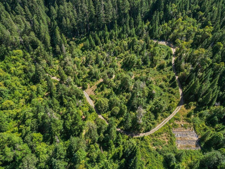 Located just 15mins North of Grants Pass, this wooded property offers creek access, privacy and seclusion with easy and quick access to the Sunny Valley exit on I5. An existing driveway leads to a clearing that is ready for your new home. Fenced in garden beds and water storage tanks (three 2,500gal) await for your gardening adventures. All information is deemed reliable, buyer to do their own due diligence. Adjacent BLM land offers even more privacy to enjoy all of the outdoor recreation that Southern Oregon has to offer!