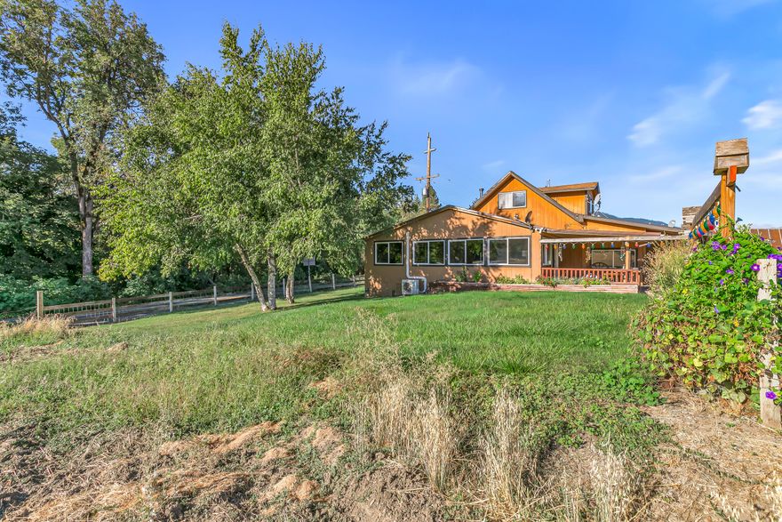 Discover a piece of Applegate Valley history on this ranch property, the site of the original Stage Coach stop. Zoned for Exclusive Farm Use (EFU), the land is equipped with great-producing wells and features a fertile, flat topography ideal for crop cultivation or a horse property. The agricultural infrastructure is well-established, with multiple greenhouses actively producing fruits and vegetables. Built in the 1880s, the home features 2 bedrooms, a spacious loft (or 3rd bedroom), 1 bath, plus a sunroom with a hot tub for relaxing after a day's work. The property also includes several cabins, currently used for storage, canning, and dehydration, offering versatile spaces for a variety of needs. In addition to barns, the grounds offer RV parking and are beautifully situated amid neighboring vineyards and mountain vistas.