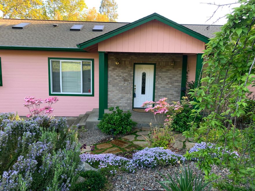 Come check out this warm and inviting home with great curb appeal. Spacious Home with vaulted ceilings, sky lights and numerous windows give this home an abundance of natural light which flows through from room to room in this lovely home.  Large kitchen with 5 burner gas stove with 2 ovens, huge pantry, garden window above sink, eat in area connected to family room. There is a dining room too.  Large deck off family room conveniently located for entertaining includes a gazebo with a ceiling fan, power and water.  Living room with recessed lighting and a view of the mountains.   Guest bath is a tub/shower combo.  Laundry is located in hall and includes washer and dryer.  Primary is spacious with recessed lighting, access to its own deck through a sliding glass door, walk-in closet and shower.  2 more bedrooms are nicely sized.  Front yard is landscaped, low maintenance and has a drip system.  Garage is heated has shelves and 2 workbenches.