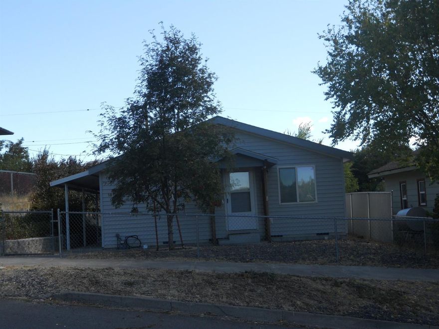 Clean 2 bedroom 2000 MF home on its own lot with 936 SF. Nice fenced yard front and back with carport plus extra parking behind the home on Wilford St. Kitchen is open to living room with lots of cabinets, laundry room is off kitchen by side door. Gas F/A heat, vaulted ceilings and good storage for its size.