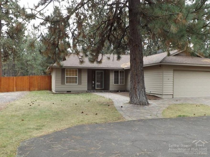 A real gem in the woods. Detached shop/garage w/finished & heated rec room (included in the square footage), plus an attached 2 car garage. Pave driveway & plenty of paved parking area, paver stone patio, & walkways, fenced, landscaped, sprinkler system, fenced RV parking all on 1.16 acres. Single level home w/granite countertops, tile floors, travertine in master w/custom glass sink. Open great room plan, vaulted ceilings. Set back from the road for added privacy. There is even a chicken coop.