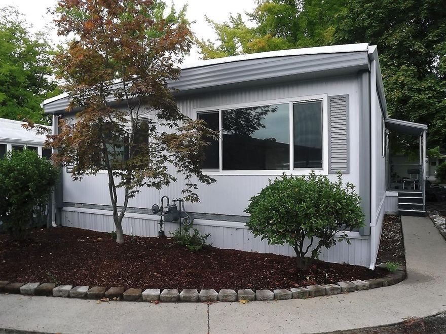 Lovely turnkey home in Rogue Lea Estates. New Carpet & flooring, newly painted inside and out. Dual pane vinyl windows through out. New skirting. New garbage disposal. All the appliances included. Ramp re-surfaced with a diamond plate installed at bottom helps you from slipping. Large living room and dining area that has built-in storage with glass cabinet doors on the uppers. Perfect for all your pretty china/collectibles. Kitchen is bright & cheery. There are 2 bathrooms & 2 bedrooms. Master bath has stall shower and is spacious with a linen closet. Master bedroom has a walk-in closet. There is RV storage available. Covered carport with storage. Home is close to lake and club house. Buyers must be approved by the park manager. Pets allowed, with manager approval. See this home today!