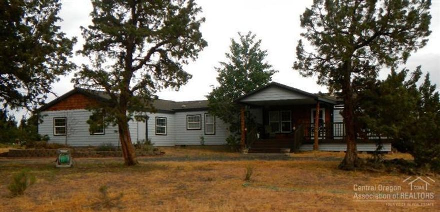 This private haven has everything you need. Lovely home features vaulted ceilings, skylights, ceiling fans, wood stove and hardwood flooring. An attached triple garage gives you space for your toys. A small storage shed is on the side.