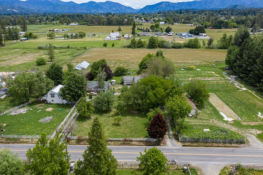 Almost 4 irrigated acres with two legal dwellings in the desirable Redwood area! This property has amazing potential! The gated entry opens to a beautiful circle drive with mature apple, cherry, and pear trees. The main farmhouse is just over 1900 SF with 3 bedrooms, 2 bathrooms, a sun room, and a large bonus room! The second home is a 2 bed, 1 bath that is
just under 1100 SF. Both homes have been tastefully updated with reclaimed wood and other modern accents. This property has 3.72 acres, a barn, and plenty of pasture for your own little farm! The adjacent parcel is also for sale and would add 3.83 acres and a 2 car garage! The property is in an excellent location with a beautiful view of the mountains offering quiet, country living close to town! Call for a tour today! This one won't last long!