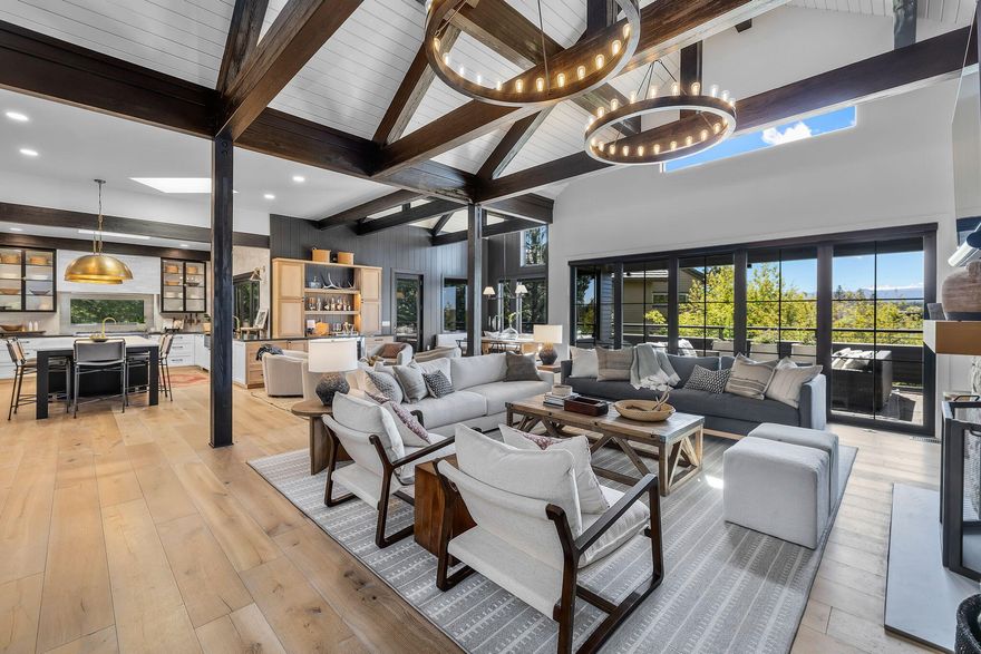 Experience luxury living at its finest in this stunning custom home with breathtaking Cascade Mountain views. Recently renovated to perfection, no detail has been overlooked in this exquisite Broken Top residence. Entertain in style in this designer showcase featuring fine craftsmanship and top-quality finishes throughout. Step into the architecturally impressive entry leading to a grand great room with cathedral ceilings and panoramic windows showcasing the awe-inspiring vistas. The gourmet kitchen is a chef's dream with Thermador appliances and an oversized island. Retreat to the sunlit master suite with a cozy fireplace, spa-like bath, and walk-in closets. Watch the sunset from the private hot tub. Downstairs, Enjoy two en-suite guest rooms with private patios, a spacious family/media room, and a spacious mudroom/laundry room for added convenience. 5th bedroom could be gym/flex room. With 3-car garage and ample storage space, this home is a true masterpiece for the discerning buyer