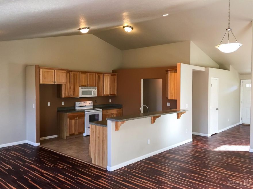 Attractive single-level ranch style home in SW Redmond. Large open plan living room that eases into dining and kitchen area. This livable home features three bedrooms. The master has a sliding glass door access to a rear patio with a fully fenced back yard. This house is located near Vern Patrick Elementary School, Dry Canyon Trail, and only minutes away from downtown Redmond.