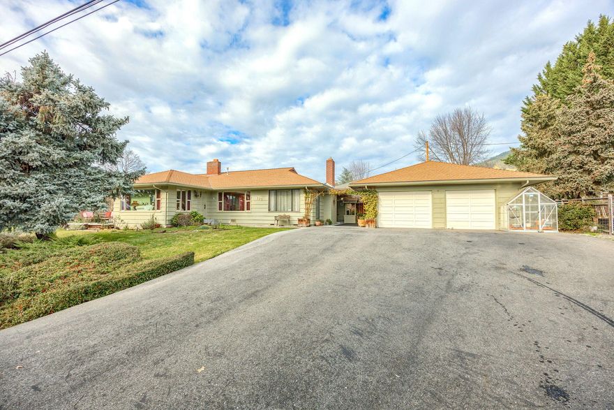 Charming home on almost half an acre at the top of town with gorgeous views!  This lovely home features 2276 sq ft, 3 beds, 2 full baths, formal living room with cozy fireplace & large picture windows to bring in the views, hardwood floors & formal dining room.  Nice kitchen with breakfast bar & abundance of cabinets,  a warm family room with gas insert & spacious bedrooms.  Outside is a gardeners dream, with a fenced garden area with raised beds, beautiful patio for outdoor entertaining & deck overlooking the mountain & valley views!  In addition, there is a 3 car garage & paved driveway.  A large, in town lot like this is a rare find. Country feel, yet close to town! Don't miss it!