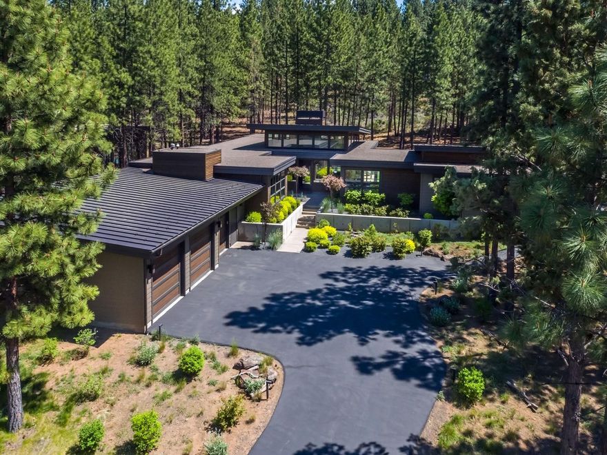 Stunning contemporary home, nestled in the woods on a quiet cul-de-sac in Tetherow. The single level plan, along with the detached casita, form a secluded & peaceful outdoor living area. The great room & office create good separation between the master suite & 2 guest bedrooms. Featuring a large quartz island, the open kitchen is designed for entertaining. Floor to ceiling windows bring the outside in; hardwood floors throughout, elegant lighting, & well designed bathrooms & closets. The master has a private entrance to the hot tub & outdoor shower. The casita, with full bath, is perfect as a guest/art studio or home gym. All offered with tasteful furnishings, selected to complement the clean and minimalist style of the home. Great 3-car garage, over 1000 sq ft. Native landscaping in the front; grassy back courtyard with a fire pit & covered dining. A fabulous location, close to schools, golf,
biking trails, downtown Bend, & the road to Mt Bachelor.