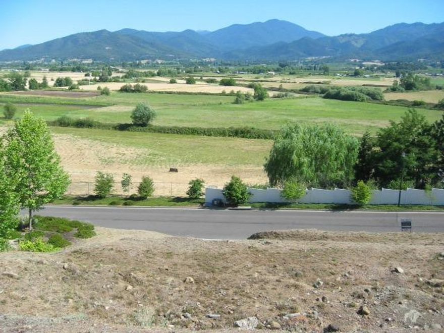 Stunning rural views of Mt. Ashland, farmland, layered hills and the meandering TID canal will remind you of Tuscany.  This is a rare opportunity to own one of the very few vacant lots that remain in Phoenix.  The lot was terraced several years ago, so an easy uphill hike will give you an idea of the spectacular views you'll be able to enjoy from your new custom-designed home.  This lot is not tied to a builder.  Subdivision plat and dedication and CC&Rs are attached under documents.  Phoenix has several new eateries, close to food trucks and a terrific cheese shop; wine tasting also nearby.