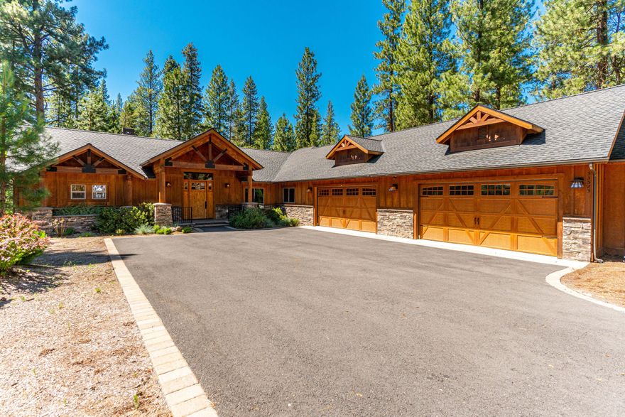 Beautiful Northwestern-style custom built home tucked in the trees in the desirable Wild River development. This one level home exudes quality and features a great room floor plan with vaulted ceilings, exposed wood beams, hardwood floors, and stacked-rock propane fireplace. The kitchen is a terrific space with granite countertops, SS appliances, high-end KitchenAid range and hood, subway-style backsplash, large pantry, and knotty alder cabinetry. The den/office affords ample space to work from home or enjoy a quiet retreat. The spacious primary suite has a more modern fireplace, dual vanity with granite counters, large walk-in closet and wood-themed tiled shower. The outside features a covered paver patio, hot tub, beautiful landscaping with irrigation, and a large 4-car attached garage with heating on one side. Wild River is located in a private community with easy access to the Deschutes River, National Forest, fly fishing, hiking, lakes, and more.