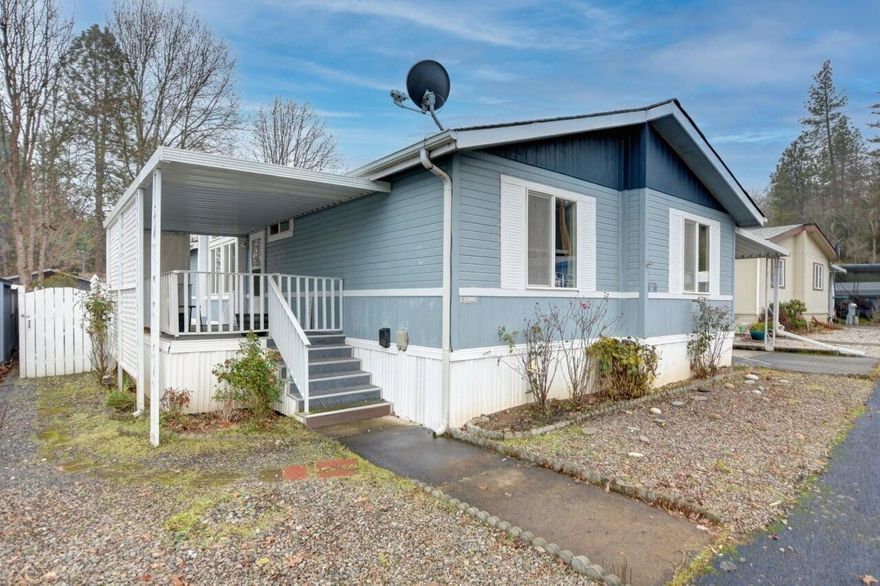 This move-in ready 3-bedroom, 2-bath home offers a desirable split floor plan, with the primary suite on one side and two additional bedrooms plus a full bath on the other. The spacious primary bathroom features two vanities, a shower, and an oversized soaking tub. Throughout the home, vaulted ceilings create an open, airy feel, while the open kitchen flows into the living room with coffered ceilings and abundant natural light. The laundry room is located just off the kitchen. Step outside to enjoy a low-maintenance yard, private covered patio, handicap-accessibility ramp, three storage sheds, a carport for up to three vehicles, and a fully fenced backyard. Located in a well-maintained 55+ community, this home offers affordable living with a $660 space rent and allows one pet up to 22 lbs. Don't miss your chance—schedule your tour today!