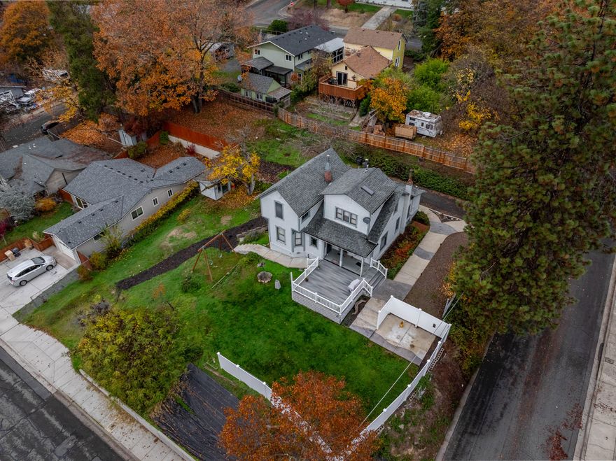 Perched like a jewel on a rare double city lot in NW Grants Pass, this iconic 1868 Victorian masterpiece blends timeless charm with 2025 upgrades. Fully reimagined yet rich in original stained glass, crown moldings, and historic soul, the 1,910 sq ft home offers 3 bedrooms, 2 spa-like baths, a grand parlor/office, chef's granite kitchen, and French doors opening to a covered porch for seamless indoor-outdoor flow. Enjoy a screened front porch overlooking manicured gardens, fresh flooring, gas heat + mini-split cooling, plus a 540 sq ft basement with wine cellar and workshop. Outside you'll find: a new decorative fence, detached shop/studio, beautiful and large Trex Deck, and a cement patio with private fence and Hot Tub connections.Zoned R-3 with ADU potential on .35 acres of private paradise. Turn-key legacy living awaits.
