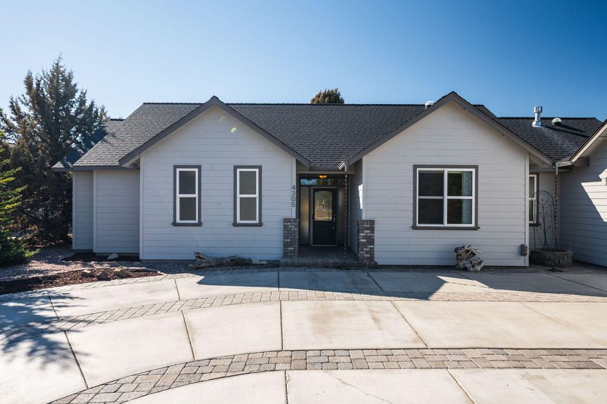 Stunning custom-built, single-level home in The Greens on a spacious, landscaped corner lot. The open-concept design, vaulted ceilings, and solar tubes create a bright, airy feel. Features include a newer Furnace/A/C, polished porcelain tile in the entry, dining, & kitchen, cherry cabinets, slab granite counters, & tiled bathroom floors. The rest of the home boasts high-end water-resistant laminate—no carpet! The updated master bath offers a large tiled shower, dual vanities, & a walk-in closet. Enjoy sound-deadening walls, gas fireplace, ceiling fans, central vac, & a butler's pantry w/ a sink & built-in desk. The expansive back deck has a gas hookup, & the front spigot w/ hot/cold water. The oversized two-car garage includes golf cart space, storage, counter space, & walkable attic access. Entertainment center, refrigerator, washer/dryer, & Murphy Bed included. Vacant, easy to show, & move-in ready! Prime location near golf, dining, Redmond Airport, w/ Bend just a short drive away