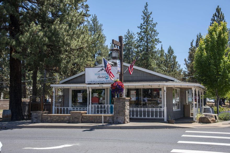When your business demands the spotlight, this corner-lot icon delivers. Sitting pretty on the west end of Sisters' bustling Main Street, this downtown commercial zoned building spans **two tax lots** totaling a shy 7000 sq ft. The Cascade Ave frontage enjoys over 12,000 daily drive-bys. Formerly home to a chocolate and ice cream shop (sweet history, right?), it's been extensively updated with smart locks, automated LED lighting, A/C, and an ADA-compliant bathroom. The open-span layout offers endless flexibility, plus private office space, ample storage inside and out, and a one-level design that says ''turn-key'' louder than your barista at 7 a.m. Zoned for multiple uses, this is where your next idea takes shape, and traffic notices!