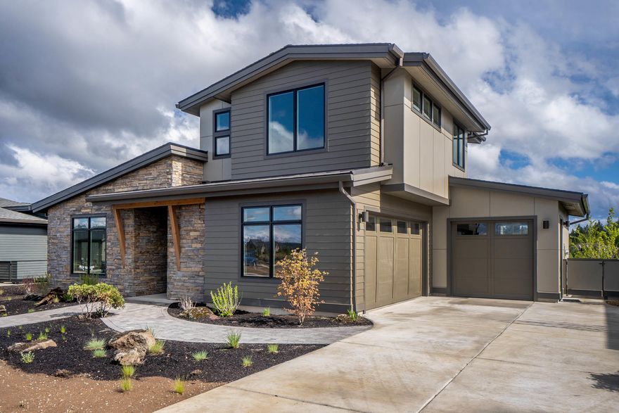 This newly completed NW Contemporary home by Simplicity Homes is perched on the high plateau at Tetherow and boasts amazing solar exposure & views of Mt. Bachelor from the patio. Offering mostly main level living with only a Jr Suite & loft style Bonus Rm up, this homes soaks up the natural beauty of its surroundings, quietly overlooking the views where the NW style is emphasized through large windows, high ceilings & warm interior finishes. Desirable great room concept and expertly oriented kitchen allow for easy entertaining while a light & view soaked dining area leads to a pavered patio for extended outdoor living. Kitchen is equipped w/ SS appliance package, beverage cooler, and gas range. Large island seats many at its breakfast bar while a convenient Mud/Laundry room also houses large pantry shelving. The master enjoys its own private outdoor entry, large walk-in closet, and modern spa-like bath with tiled walk-in shower and soaking tub.