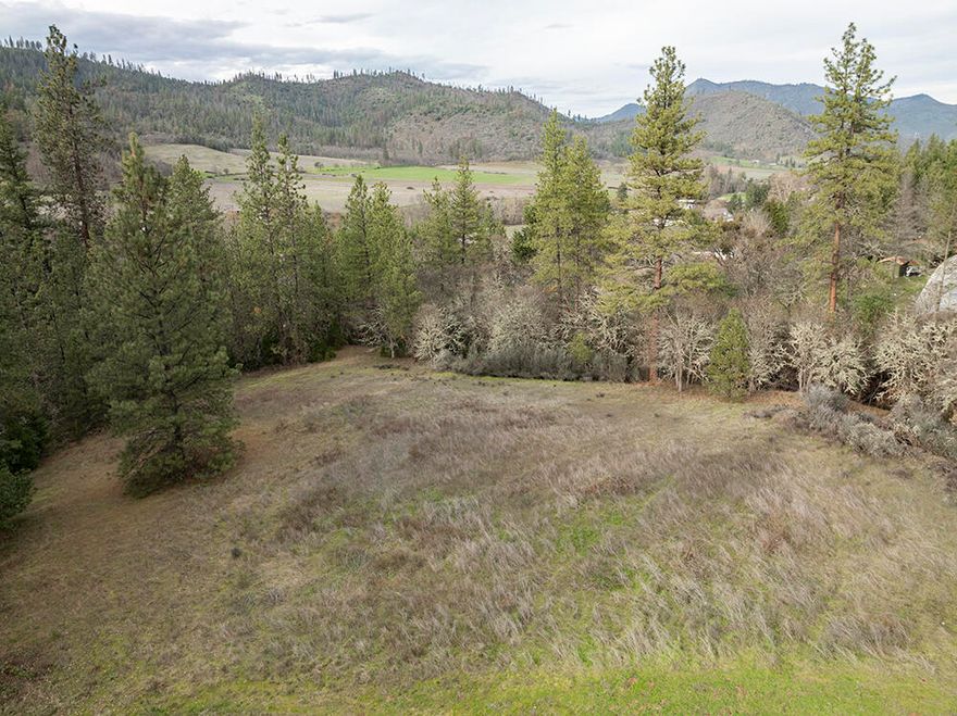 Yes, this is what we love about Southern Oregon! Embrace the essence of rural living on 5.16 acres in the heart of the Applegate Valley. An established dirt driveway guides you to your private meadow atop the hill, where panoramic views of the mountains and valley below await. This prime parcel offers the perfect opportunity for your future homesite. Nestled in wine country, with numerous wineries nearby, it's also conveniently close to Applegate River recreation, local amenities such as restaurants, store, church, and school. Welcome to your ideal building site, where the beauty of nature meets the comforts of community living. All information deemed reliable but not verified. Buyer to perform their own due diligence.