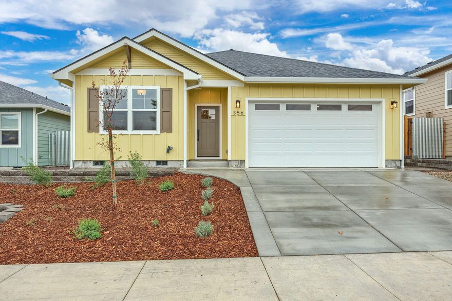 Come see this newly completed home by Taylored Elements Construction just a few minutes from downtown Ashland. It is single level, with 3 beds, 2 baths, has an open floor plan, gas fireplace in the living room, vaulted ceiling, lots of windows for abundant natural light, engineered hardwood floors in main living areas, carpet in bedrooms, tile floors in bathrooms & laundry room, quartz countertops and custom cabinets with soft close drawers throughout. The farmhouse sink in the kitchen island, full tile backsplash, stainless steel appliances and pantry cabinet add to the luxurious feel. A primary suite bedroom wall has a special treatment for extra character, walk-in closet, dual sinks & tiled walk in shower. Utilize the back patio and fully landscaped yard with drip irrigation and 6 foot fencing. Earth Advantage standard build certification provides green features & energy efficiency with solar panels, EV charger in the 2 car garage and ductless heating and cooling system.