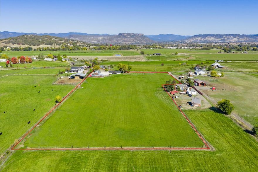 Exceptional Property: Two homes, both single level & well-maintained, located on 9.86 lush, irrigated acres w/expansive views of the Table Rocks, Mt McLaughlin, Roxy Ann Peak, & more.  This area of Scenic Ave is a desirable central location that offers the best of both worlds: near-town convenience paired with a peaceful rural setting. Level, productive, & user-friendly land, (8.4 acres) RRV irrigation dist., updated 10'' lateral in place. This is a fantastic two-family setup or use the rental income. The main home has been beautifully maintained/nicely updated: brand-new roof & concrete driveway, lrg. covered patio, hardy siding, vinyl windows, flooring, bathroom & kitchen updates. The 936' sqft 1 bed/1 bath 2nd home: rented $1,000 mon-mon, has great floor plan w/office/hobby rm, open liv/dining area, kitch/utility rm. & covered frnt porch. Offers (2) separate shop buildings: (1) w/office/storage, full bath, lrg door & is heated, large barn, generator, all w/fantastic access & parking