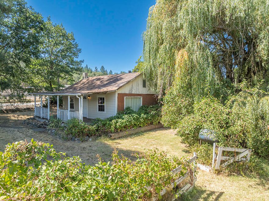 Perfect Fixer/Project Home on just over an Acre of Land between Grants Pass and Murphy! This Cottage-Style Single-Level Home was lived in until recently, but is in need of Cosmetic and Structural Work. The Home is Dry inside, and does offer some Good Floor Plan Features. Additionally, the Property has a Nice Shop-Type Building, that has the makings of an ADU/Guest Quarters or a Cool Studio Space. There was a Hardship Dwelling in place on this Property for many years, so the benefit of an Additional Separate Access and Water and Septic Connection is available. The Land here is Level and Useable, with Pretty Mountain Views, Numerous Fruit Trees, Garden Space, and a HUGE Awesome Redwood Tree! Ideally located just a few minutes away from Town, and perfectly set up for Animals and Kiddos to roam and enjoy. If you have been looking for a Bargain, or a Project to Earn Equity from your own efforts, this is the one for you. Priced literally at Land Value, but with so much more to offer!