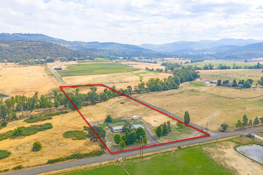 Enjoy 9.06 acres of rural living, perfect for creating your dream. Ideal for outdoor enthusiasts, the property is mostly flat, fenced and has some cross-fencing.  Surrounded by equestrian and cattle ranches, this property is a great start to your country living dream.  Relax to the sounds of Antelope Creek gently crossing the back acre of property.   Live in the well cared for mobile home or build the home you want. The detached garage has shop space and additional space can be found in the shed.   This property is nestled in privacy, and offers views of the surrounding landscapes while being located close to the amenities of town. Whether you're looking for a country retreat or a permanent homestead, this property combines natural beauty, versatility, and opportunity. Don't miss the chance to own a piece of country living. SHOWN BY APPOINTMENT ONLY.