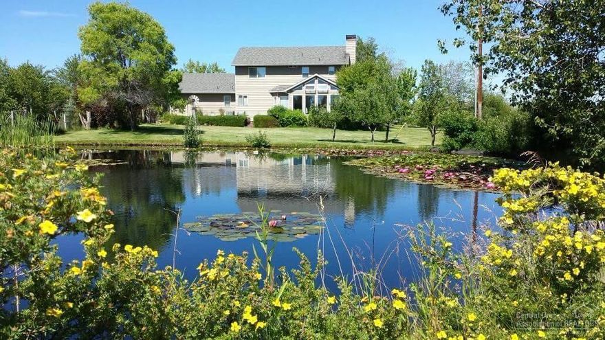 A gardener's paradise with mountain views! An Oregon Master Gardener has created a virtual arboretum as the center piece for this 2284 sq. ft. 3/2.5 home with raised beds, pond, N.W. Green panel greenhouse, 30' x 24' pole barn for storage, horses, llamas, etc. BLM & USFS lands close by. A spacious Sun room inside overlooks a pond, shrubs, trees, flowers, plants & acres of pasture and irrigated hay fields. Pantry, living room, family room, dining areas, office and an attached extra deep two car garage.