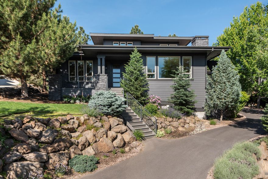 Extensively remodeled in 2022, this Awbrey Park home exudes contemporary sophistication. The unified aesthetic between form & function begins in the foyer's detailed craftsmanship in the walnut flooring highlighted by natural light & vaulted ceilings. The open floor plan provides sweeping views of the Ochoco Mountains & colorful treetops. Kitchen greats Miele, Bosch & Dacor take center stage in the sleek kitchen. The dining room features one of many designer light fixtures. Enjoy a cocktail or conversation in the lounge before retiring to the spacious primary suite with a luxury bath and deck access. Also on the main floor is an inviting en suite bedroom & office. Upstairs, 2 ample bedrooms share a full bath. Gorgeous hickory flooring extends to the bonus room with even better views & space to unwind, play or create. Integrated technology extends to even the 3-car garage. Awbrey Park offers a park, playground & access to the Deschutes River Trail. Complete furniture package for sale!