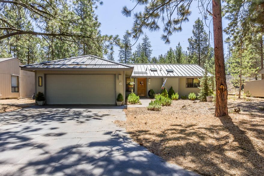 Charming and thoughtfully updated home in the heart of the Sunriver Resort - welcome to 6 Timber Lane! This single level property features vaulted ceilings with a metal roof, tile floors, quartz countertops and all-stainless appliances, including a gas range. Cozy up next to the Austrian pellet stove on a cold day, or step out through the living room slider onto your wrap-around cedar deck. Head down the hall to the primary bedroom and two guest bedrooms. Both the primary ensuite bathroom and guest bathrooms feature beautifully tiled surrounds, quartz-top vanities and vessel sinks. The attached 2 car garage provides ample room for parking/storage. Come and enjoy everything Sunriver has to offer!