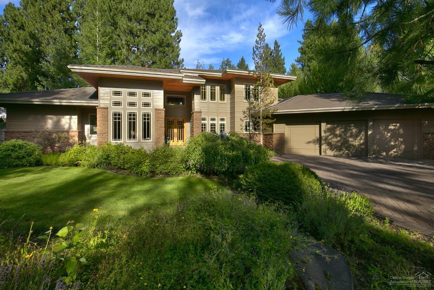 Spectacular custom built Prairie style home in the highly sought after gated Broken Top community. Exceptional quality craftsmanship instantly greets you as you walk by the water feature & through the stunning stained glass front entry doors into the grand entryway. Main floor luxurious master suite with large walk-in closet. Unwind in your oversized soaking tub while looking out into your private garden patio. Office with custom built bookcases, spacious formal dining area, living room with vaulted ceilings & floor to ceiling windows, family room with wood burning fireplace, bar area, gourmet kitchen with island & breakfast nook. Walk up your grand staircase to 3 en-suite guest rooms. Attached 3 car garage. Expansive outdoor area with trees & large paver patio makes this home an entertainers dream. Set on a private .41 acre estate lot. Enjoy Broken Top amenities: golf, clubhouse, community pool, tennis and more. Make this home yours & enjoy all that Central Oregon has to offer.