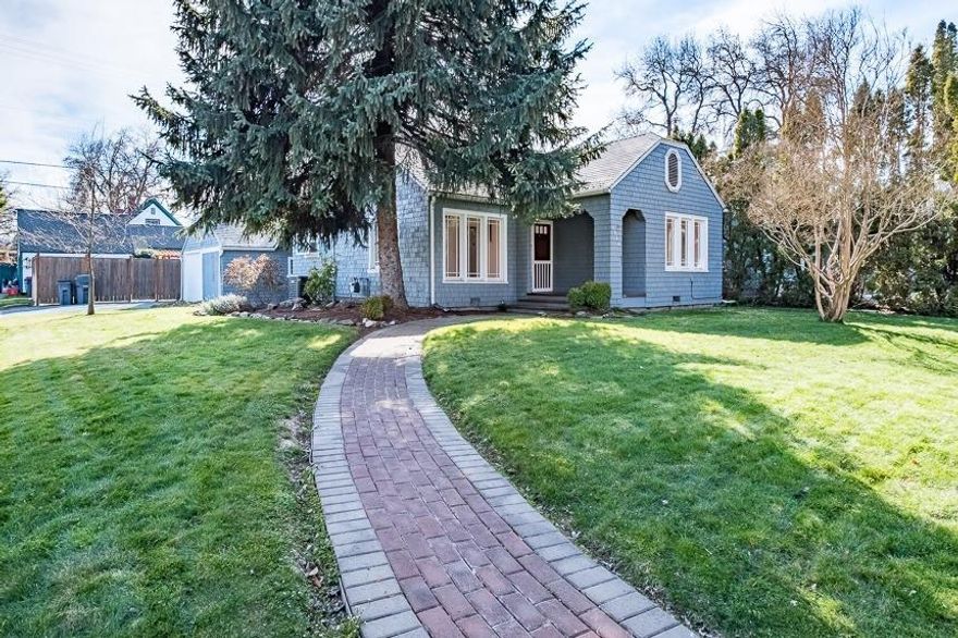 Wonderful home in Old East Medford. This 2 bedroom, 2 bath, 1370 sqft home sits on a large, well manicured corner lot. Inside you will find a warm gas fireplace complete with tile surround, wood windows, and kitchen with ample storage. The living room is open to the dining room with beautiful hardwood, and plentiful natural light. The Master suite features a walk-in closet and a master bath with a double vanity. There is a second bedroom upstairs, perfect for a man-cave, sewing room or kids play space. Washer and dryer are in the basement, with a room that could be used as an office of a third bedroom. The large detached garage has custom pegboard walls for organization, and space to park your car. A large fenced backyard with a beautiful deck makes it perfect for entertaining! Call today to schedule your showing!