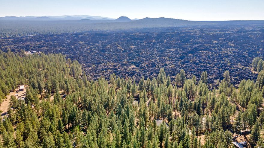 Discover the untamed beauty of Central Oregon with this unique 2.84-acre property nestled beside the breathtaking Big Obsidian Lava Flow from the Newberry Volcanic Crater. Towering pine trees offer privacy, shade, and a true sense of serenity on this secluded Southwest Bend parcel.
The land features a 2,339 sq ft home that's ready for your vision. Whether you want to renovate, restore, or start fresh with a custom build. Plus, enjoy the added value of a 1,500 sq ft heated shop, perfect for hobbies, storage, or a home business.
With direct access to some of the region's most striking natural features and endless recreational opportunities nearby, this property is ideal for anyone looking to create a one-of-a-kind retreat in the high desert.