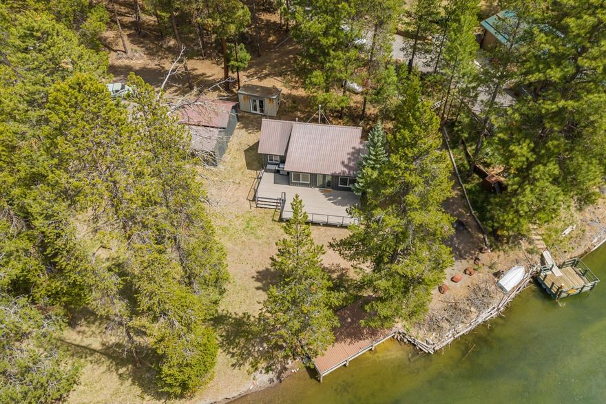 Updated riverfront Cabin in the sought after Haner Park community. 110 beautiful feet of river frontage, on a spacious and private 0.78-acre lot with its own private dock! This gem can be sold mostly furnished and is ready to be used as your next vacation retreat. New large front Trex deck, a large storage shed, and an additional finished building that could be used for extra storage or more living space. Step out your front door to fly fish, or head out on your kayak for a serene river float. Surrounded by great trails for cross country skiing and snowmobiling in the winter! This is your perfect all season vacation cabin!