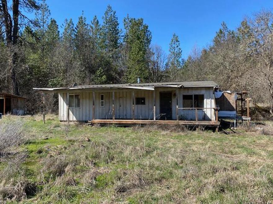 Lots of potential with this usable acreage that offers a small home, a shed and pole barn.  Private setting and set back off the road.