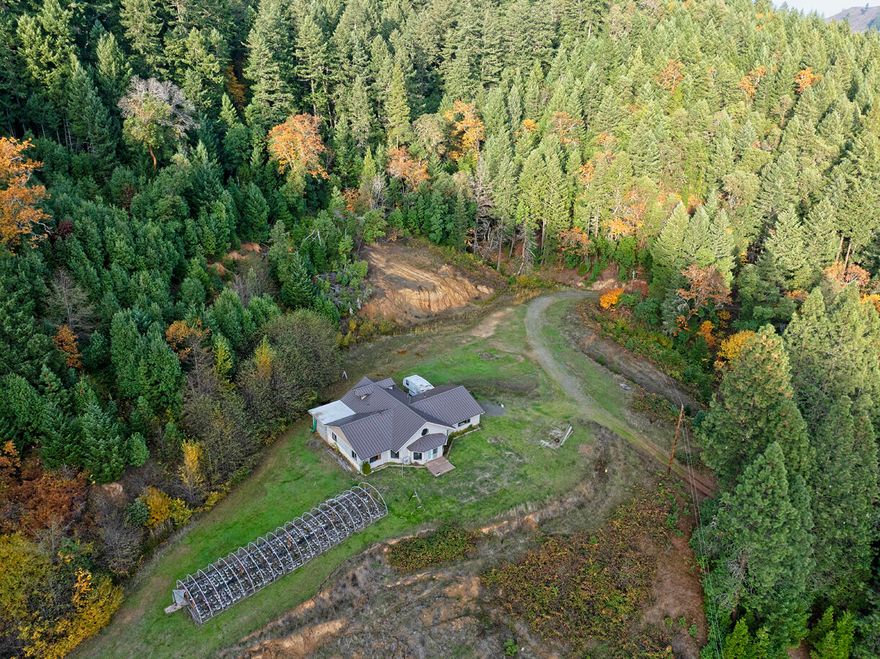 Discover nearly 140 acres of privacy across two unique Wolf Creek properties offered as a bulk package. The 3BD/2BA, 3,100+ sq. ft. mountain retreat features an open layout, custom burl wood counters, remodeled bath, built-in gun cabinets, attached cold room, guest house, pond, and marketable timber. Trails run throughout and the land is bordered by BLM on two sides. The additional 40-acre historic 1870 home offers vaulted ceilings, open floor plan, remodeled bath, walk-in closet, and a serene seasonal creek. Both properties provide exceptional seclusion, natural beauty, and limitless potential for a private compound or multi-home retreat.