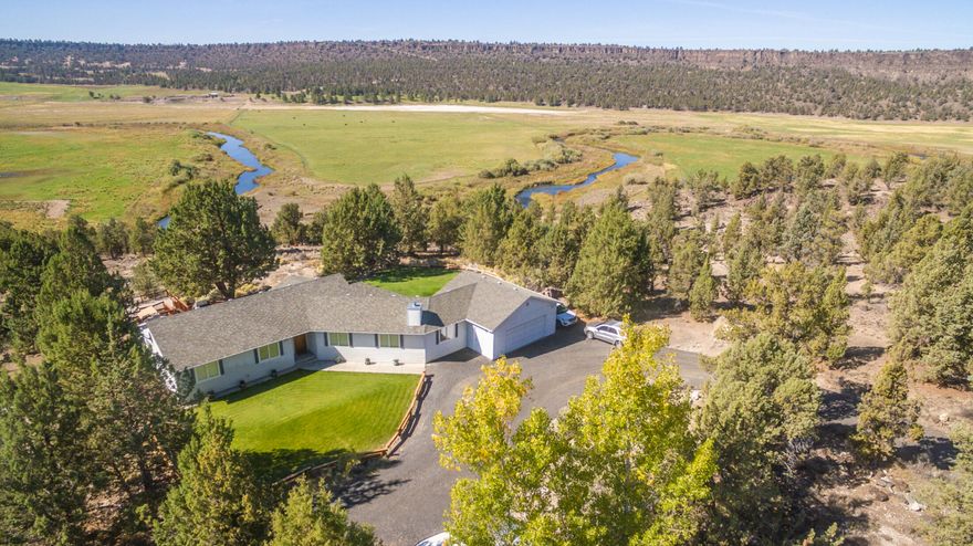 Located just a short 2 miles out S Crooked River Highway nestled in the trees there is this gem of a property.  If you are looking for privacy and seclusion, lots of space to stretch and wonderful views of the Crooked River valley and the Crooked River meandering through the farmland this may be the property for you!  15.8 acres with a private drive, nicely landscaped and a lovely 1815 square foot home with 3 bedrooms, 2 baths, large family room and vaulted ceilings in the main living area.  There is a 2-car attached garage and a brand new 18x22 pole building.  Central vac system, hot water recirculating system, water softener, and a whole house generator for backup power!   Step out the back door to a wonderful outdoor living area with an amazing deck, gazebo, and patio to enjoy.  Great for entertaining or just relaxing and taking in the sights and sounds of nature that surround you.